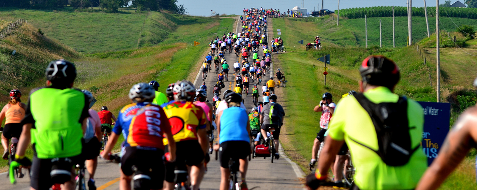 Cyclists climb uphill during a non-competitive bicycle ride in Iowa